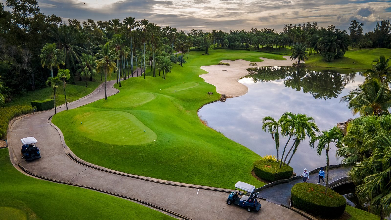 Aerial view over a green and lake at Alpine Golf Club