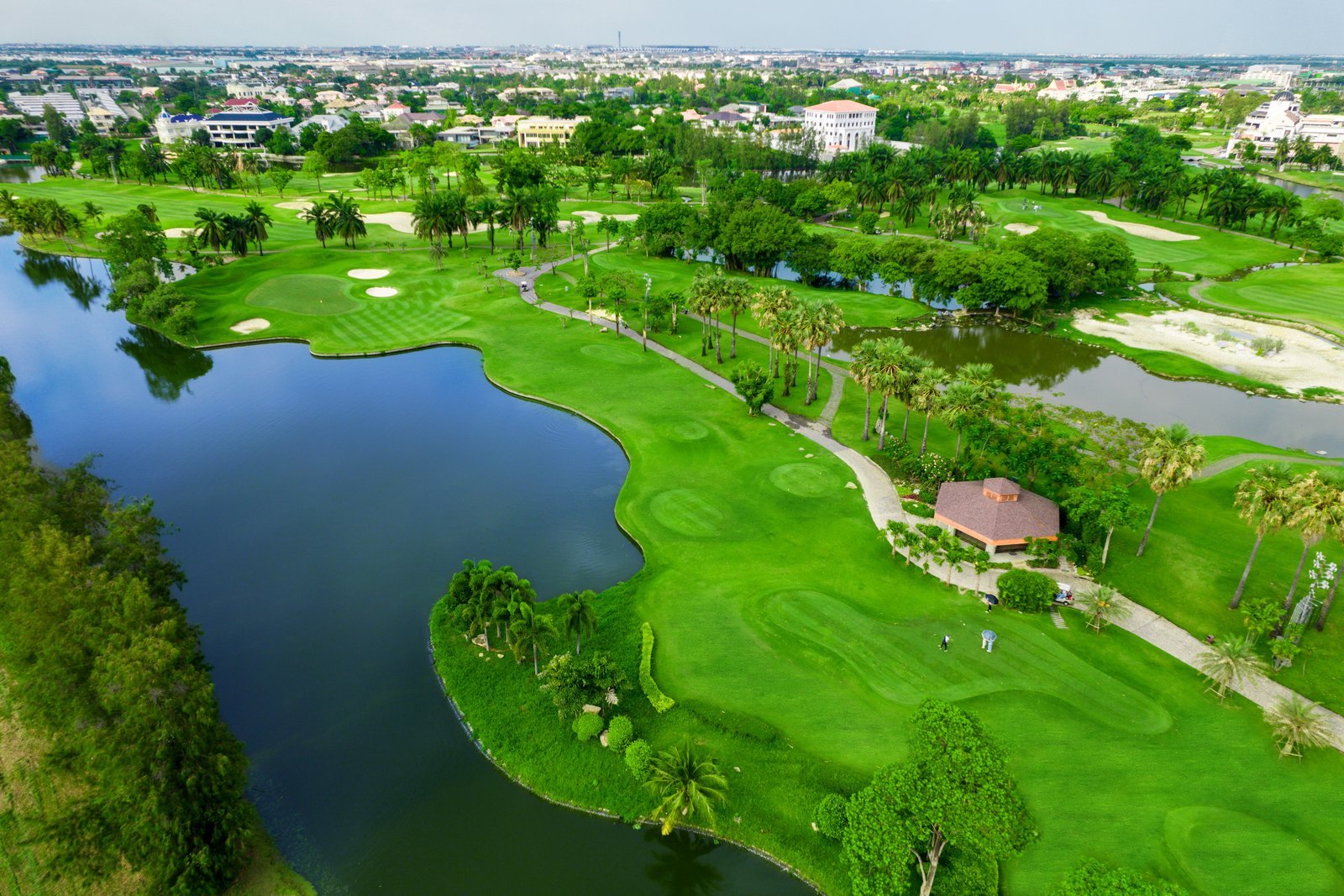 Aerial view of the fairways, lakes and palms at Summit Windmill Golf Club