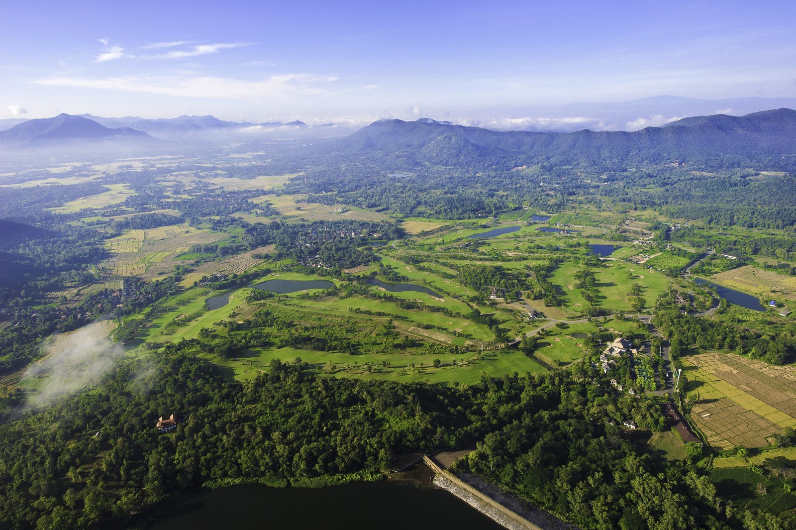 Aerial view of Chiangmai Highlands laid out along the valley floor with the northern mountains behind