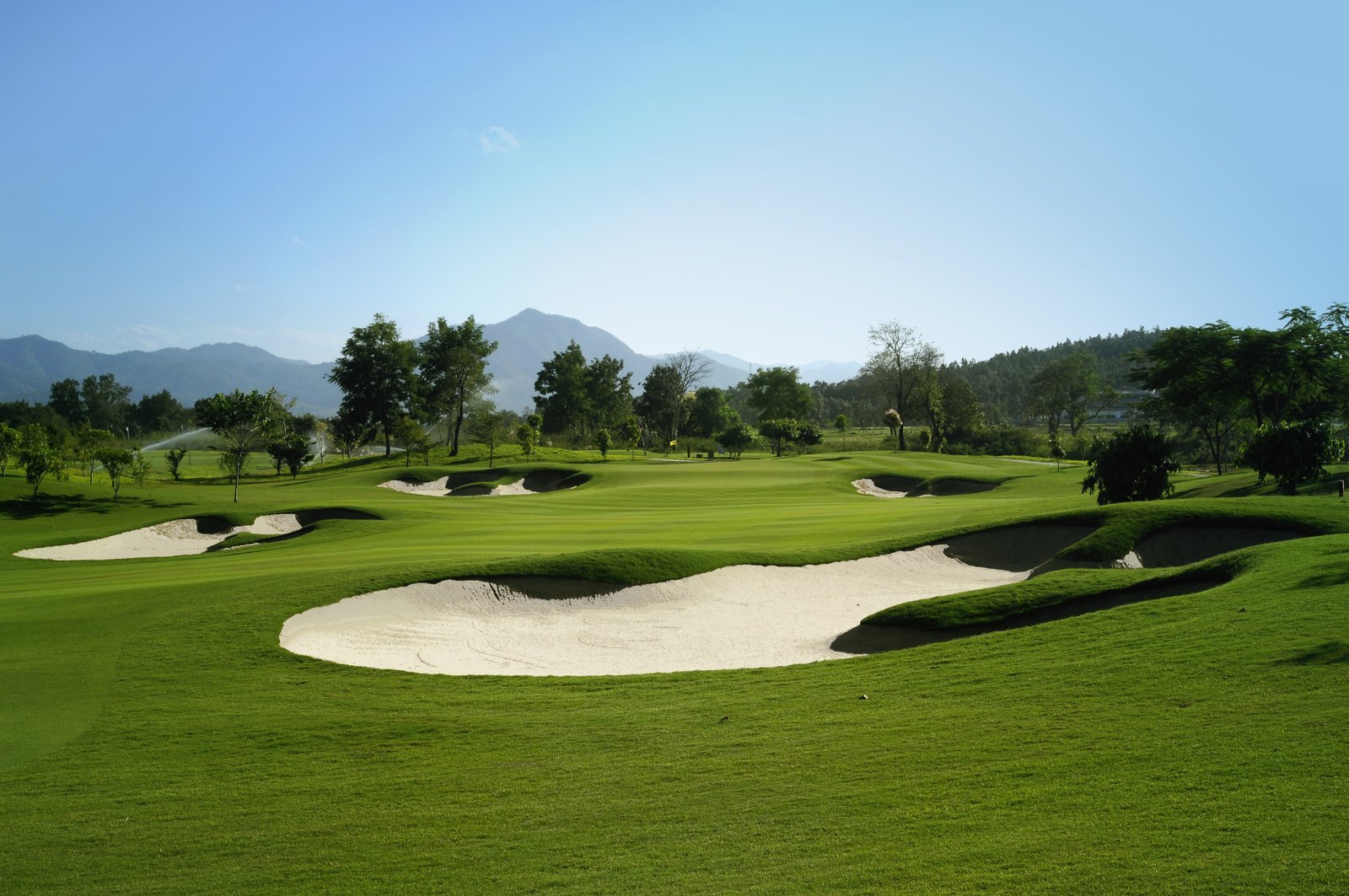 The opening green at Chiangmai Highlands, framed by deep bunkering