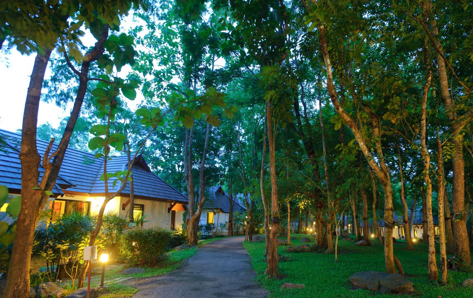 Garden villas at the Chiangmai Highlands resort, lit at dusk