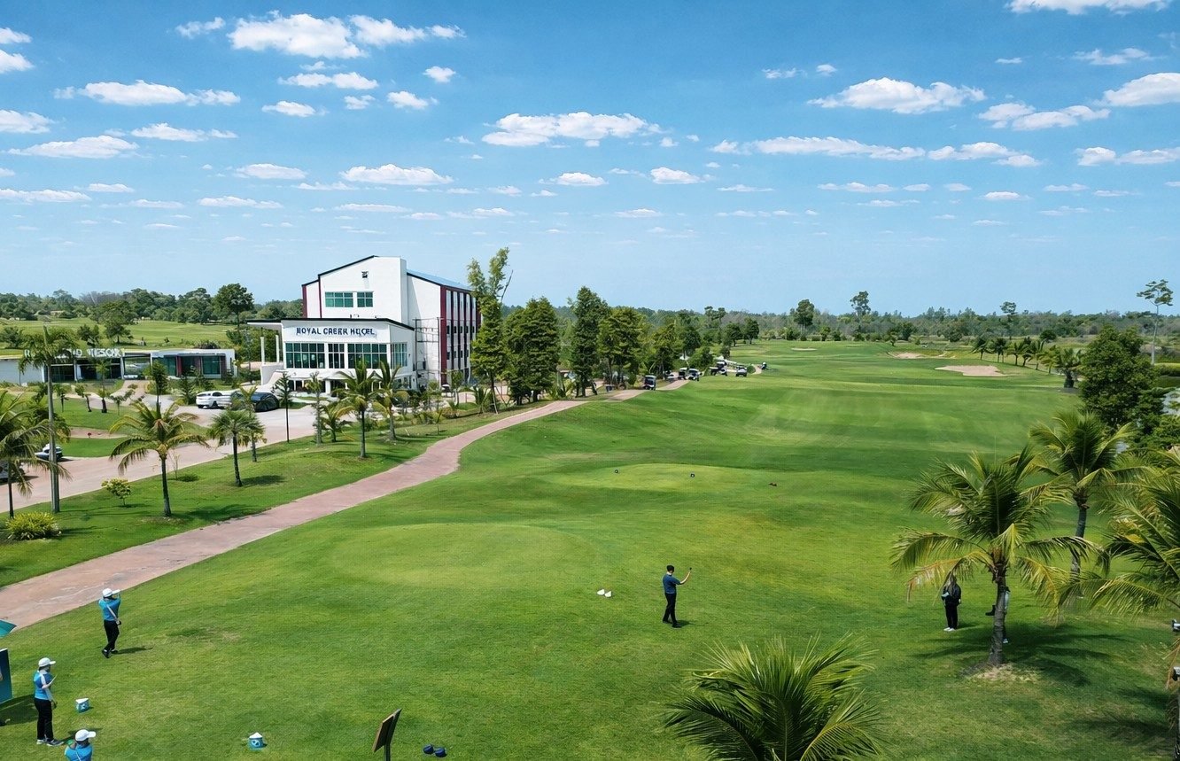 Royal Creek Golf Club and Resort — fairway with the resort building behind