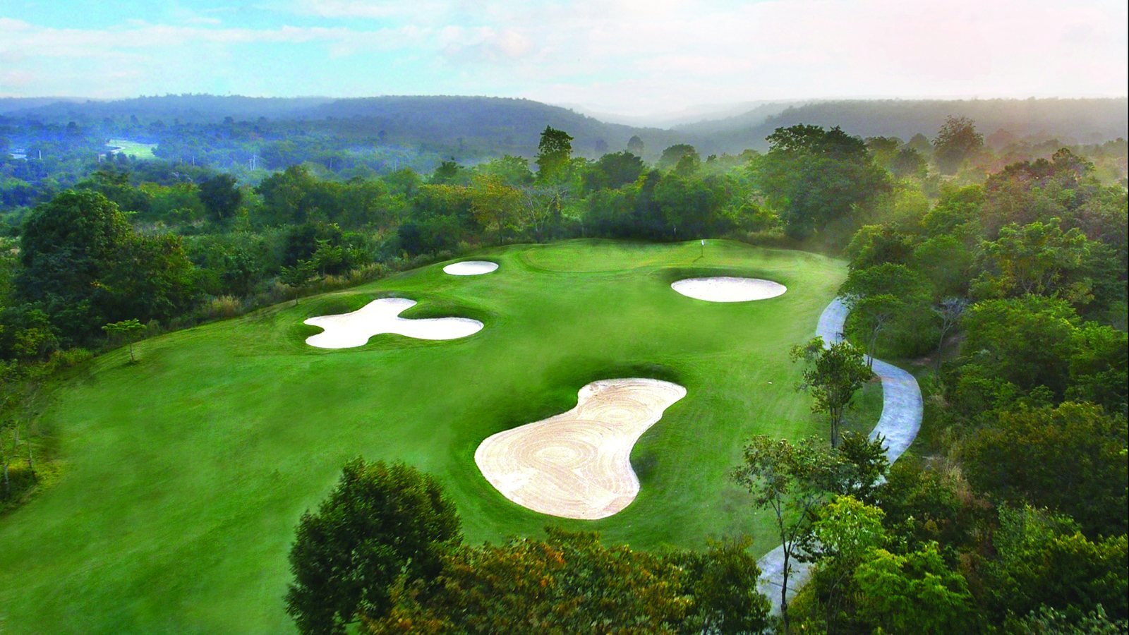 Misty morning over a green and bunkering at Mountain Creek