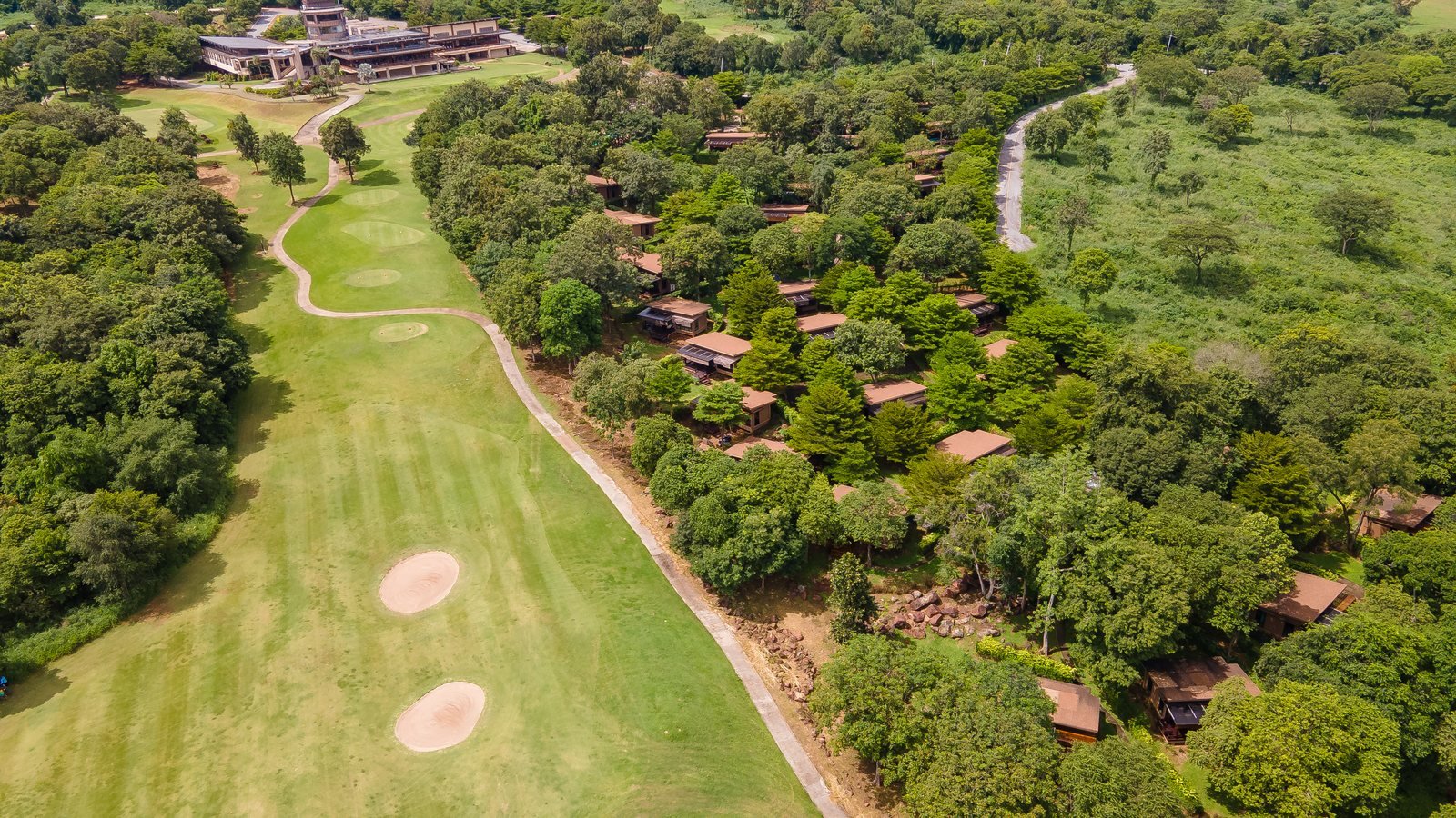 Aerial down a fairway towards the villas